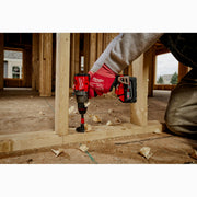 Person using a Milwaukee power drill on wooden construction