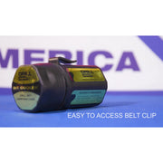 A black and dark gray Drill Bit Cooler camping case with a yellow and green label, featuring a belt clip, shown on a blue surface with a blurred background and text overlay 'EASY TO ACCESS BELT CLIP'.